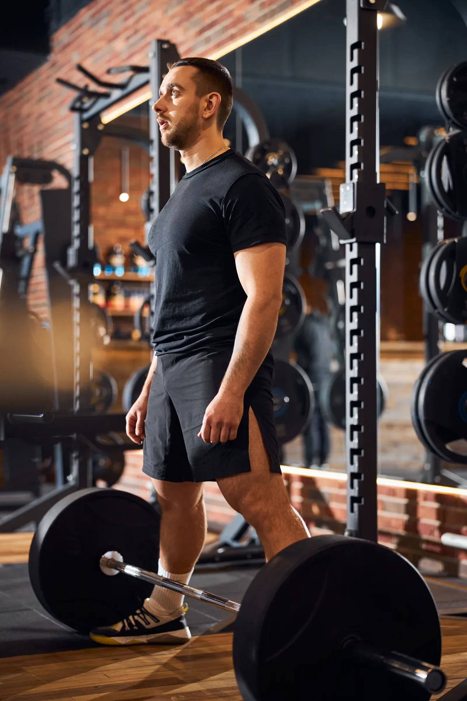 Man preparing to lift a loaded barbell in a gym
