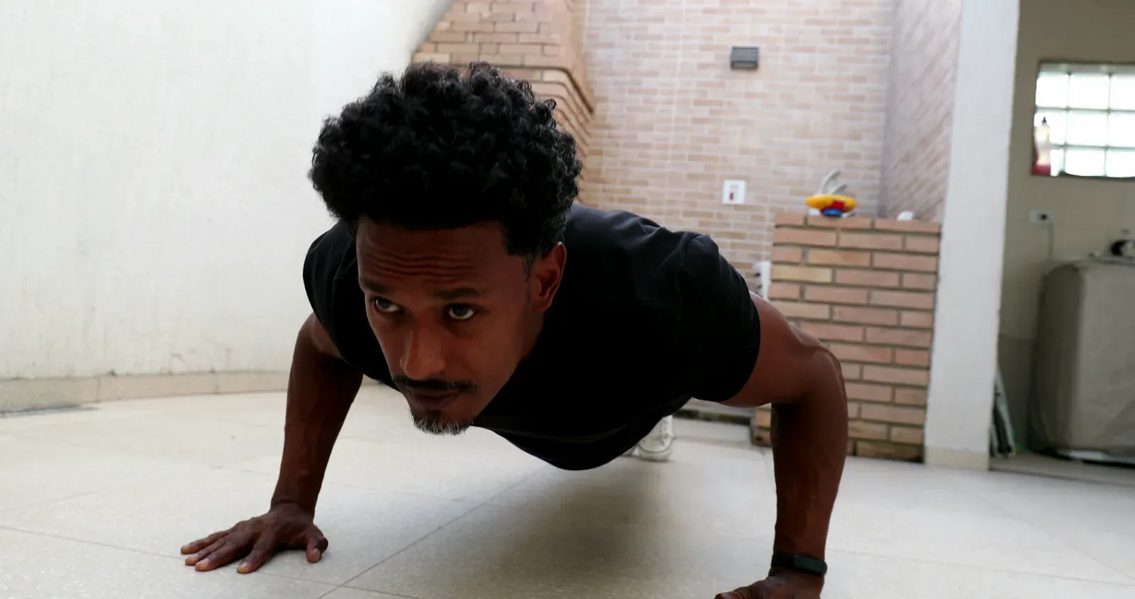 Man doing push-ups on the floor at home